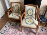 two chairs that are sitting in front of a fireplace