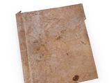 an old book on a white surface with a white background