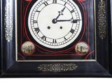 a black and white clock with pictures of people on it