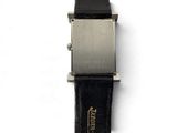 a close up of a watch on a white surface with a black strap
