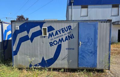 a blue and white sign on the side of a building