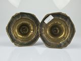 pair of antique brass candlesticks on a white background