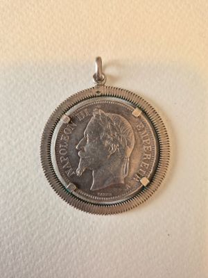 a close up of a coin on a white surface