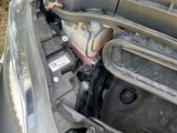 a car that has a broken hood and engine in it