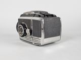 an old fashioned camera sitting on a white surface