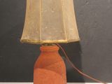 a lamp that is sitting on a table with a lamp shade on it
