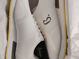 a box with a pair of white shoes inside of it
