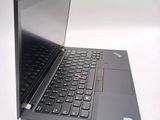 a laptop with a black keyboard on a white surface