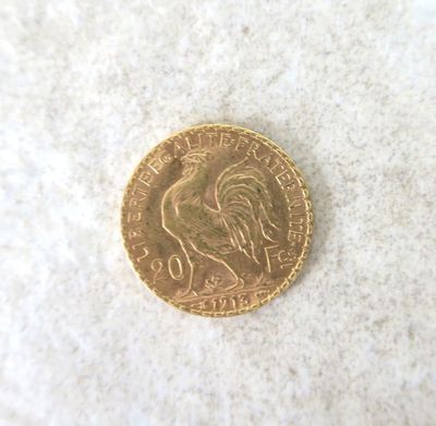 a gold coin with a picture of a rooster on it