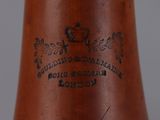 a close up of a brown vase with a label on it