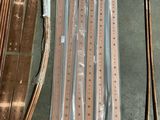 many pieces of copper on the floor next to a pair of skis