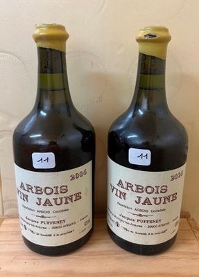 two bottles of wine sitting on top of a wooden table
