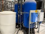 a large blue tank sitting next to a white container