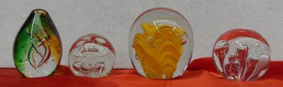 five glass vases with different colored flowers in them