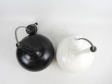 two black and white teapots on a white table