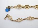a close up of two gold bracelets with blue stones on them
