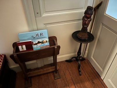 a small table with a book on it next to a door