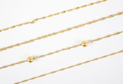 three gold chain necklaces on a white background
