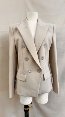 an image of a woman ' s jacket on a mannequin