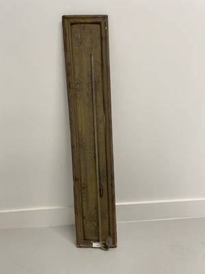 an old wooden door leaning against a wall in a white room
