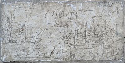 a stone plaque with a drawing of a ship on it