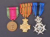 three medals and a medal on a black background