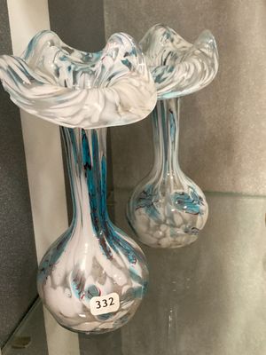 two glass vases that are sitting on a glass shelf