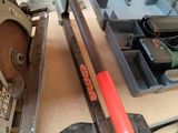 a table with tools on it that include a saw, a tool holder, and a tool tray