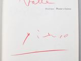 an open book with a handwritten title and a red marker on it
