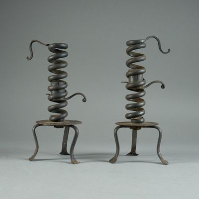 pair of metal sculptures of a snake and a snake sitting on a stool