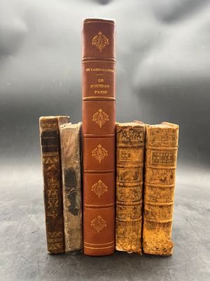 three old books stacked on top of each other on a table