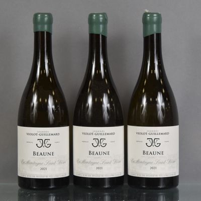 three bottles of wine are lined up on a glass table