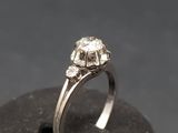 a close up of a diamond engagement ring on a rock