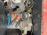 a metal container with tools in it on the floor