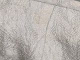 a close up view of a bed with a white comforter