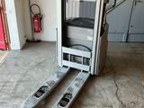 a forklift with two skis on it in a garage