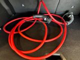 a red hose attached to the back of a car