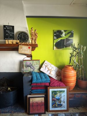 une pièce avec une cheminée et plein de tableaux accrochés au mur