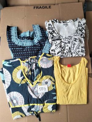 three shirts are sitting on a cardboard box on a table