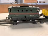 a toy train on the tracks with a skeleton on top of it