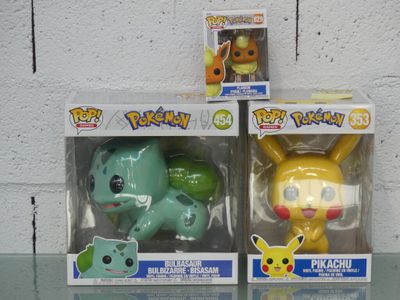 two boxes of pokemon toys sitting on a glass table