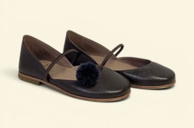 leather ballerina shoes with pom poms on the toes