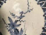 a blue and white plate with a floral design on it