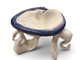 a blue and white bowl sitting on a stand