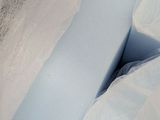 a close up picture of a bed with a blue comforter