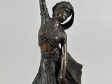 bronze statue of a female dancer on a marble base