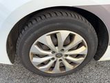a close up of a tire on a white car