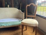 a couch and a chair in a room with a window
