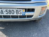a silver car that is parked on the side of the road