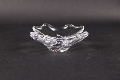 a close up of a clear glass bowl on a black surface